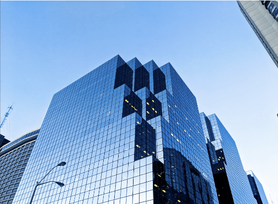 Modern glass office buildings reflecting the sky in a downtown business district