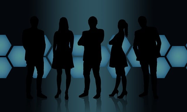 Silhouettes of five business professionals standing together