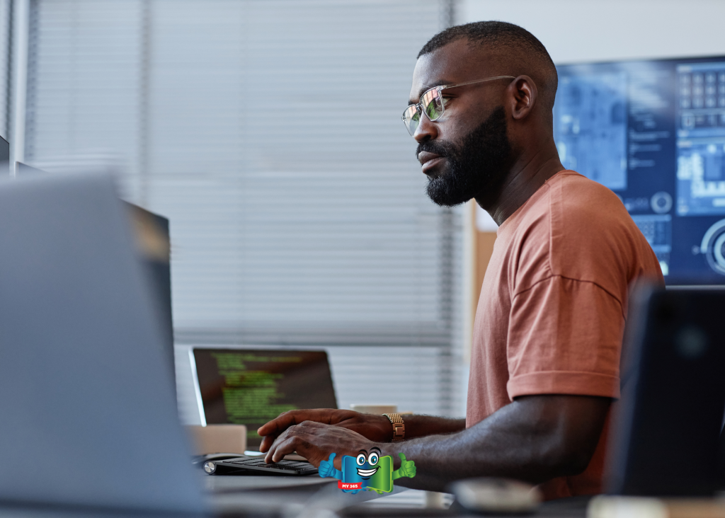 Man working at a computer in a modern office environment.