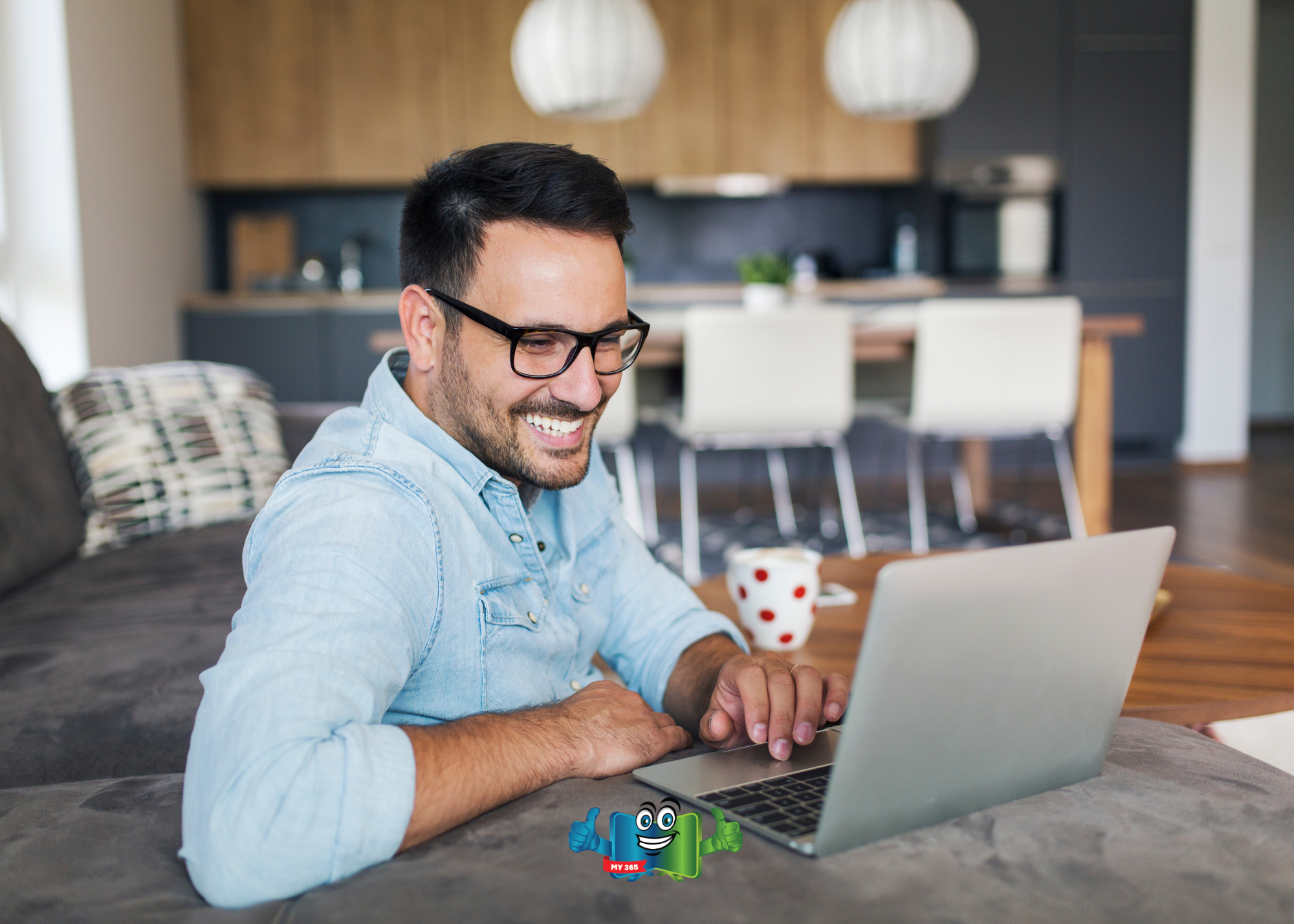 Man using a laptop while sitting on a couch in a modern home.