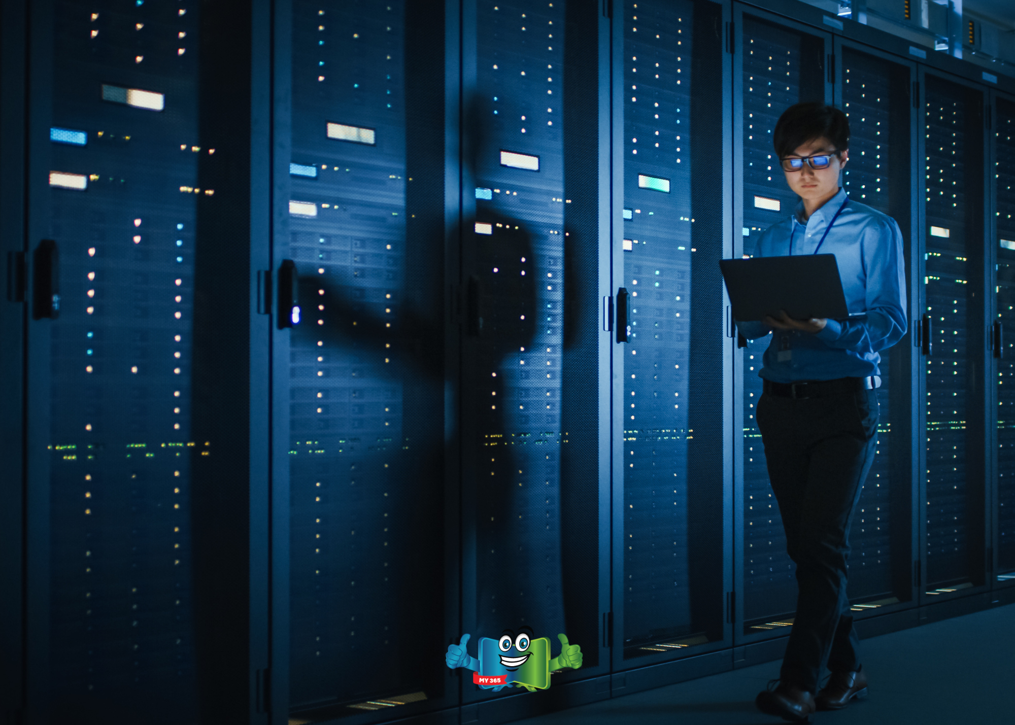 Person using a laptop while walking through a data center with server racks.